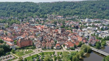Luftbild von der Künzelsauer Innenstadt, im Vordergrund Grünanlagen, Parkplätze und das Schloß